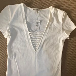 White shortsleeved shirt with design in front.